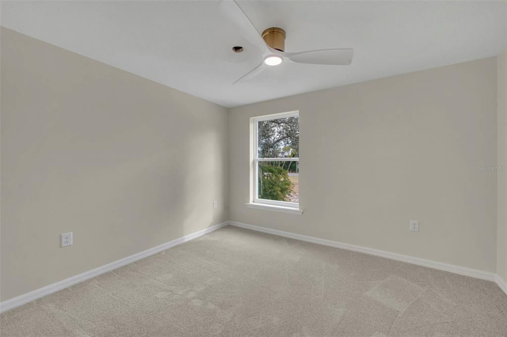 31201 Merry Road Tavares, FL 32778 - Photo 33 of 40 an empty room with a window and a fan