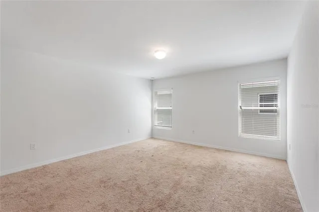 an empty room with a empty space and windows