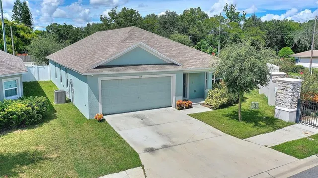 a aerial view of a house with a yard and potted plants
