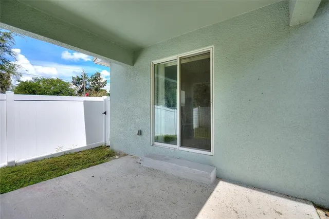 a view of a backyard with potted plants