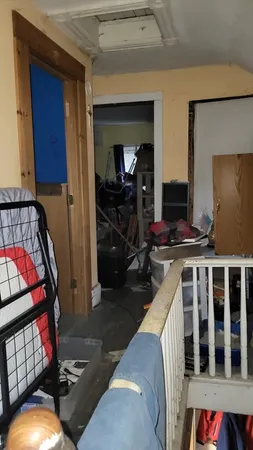 a view of a livingroom with furniture and staircase