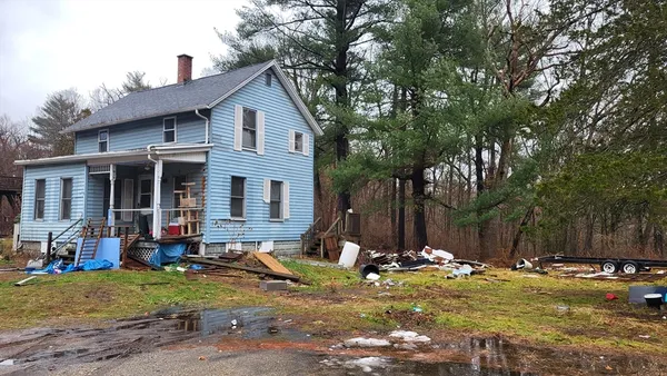 a view of a house with backyard and trees