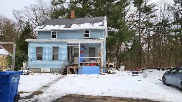 a view of a house with snow in the backyard