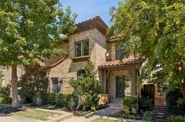 front view of a house with a tree