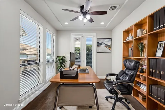 a bedroom with a large bed a chandelier and a window