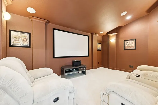 a spacious bedroom with a bed a couch and a chandelier