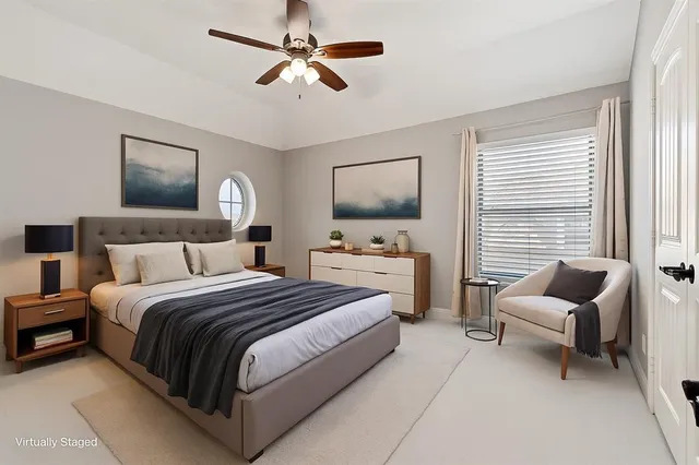 a bedroom with a large bed and a chandelier