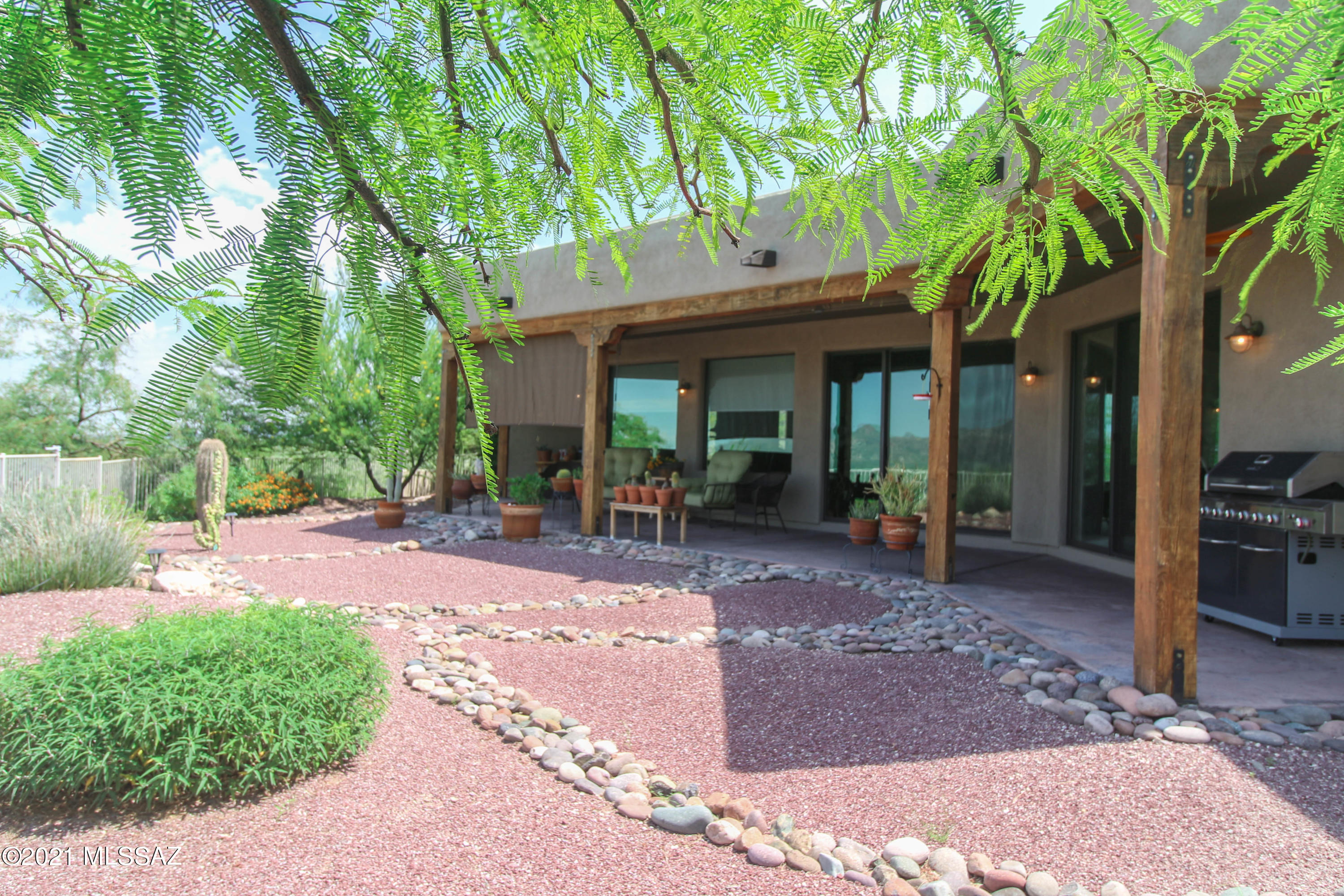 1567 Camino Esturion Rio Rico, AZ 85648 - Photo 10 of 41 a view of a patio with table and chairs next to a yard