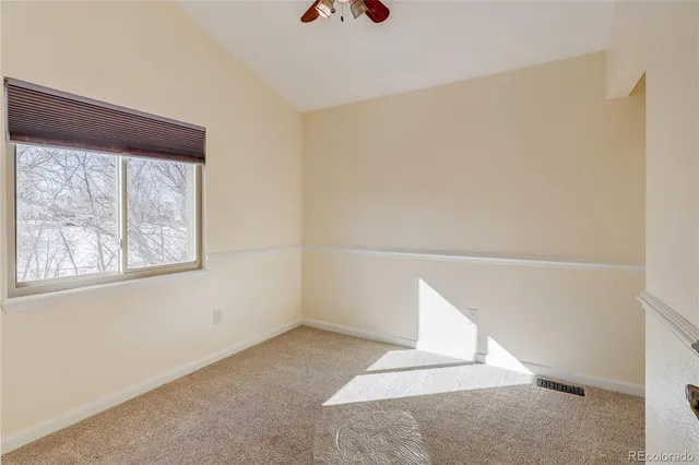 a view of an empty room with windows