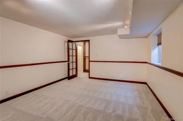 a view of walk in closet with empty racks