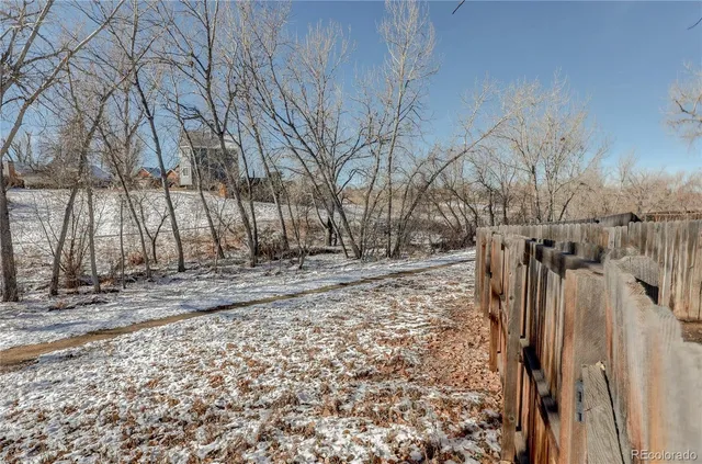 a view of a yard covered with snow in the yard