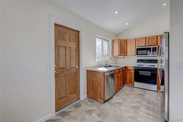 a kitchen with a refrigerator stove and sink