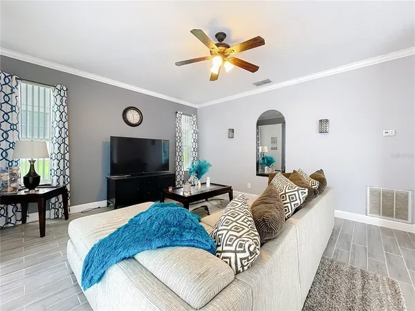 a living room with lots of furniture and wooden floor