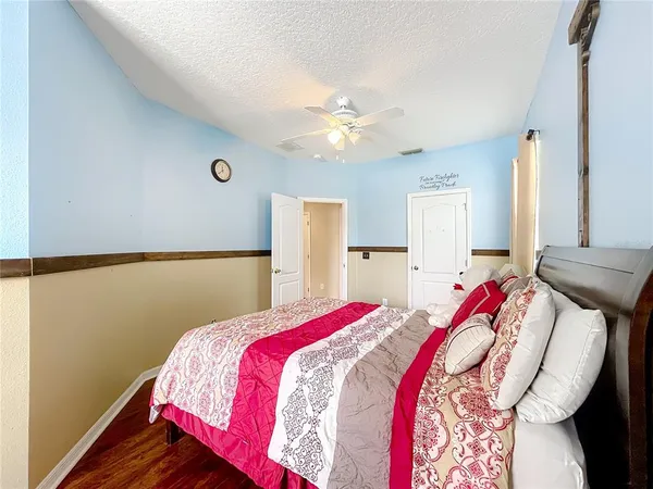 a bedroom with a bed and a chandelier