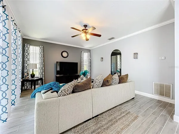 a living room with furniture and a wooden floor