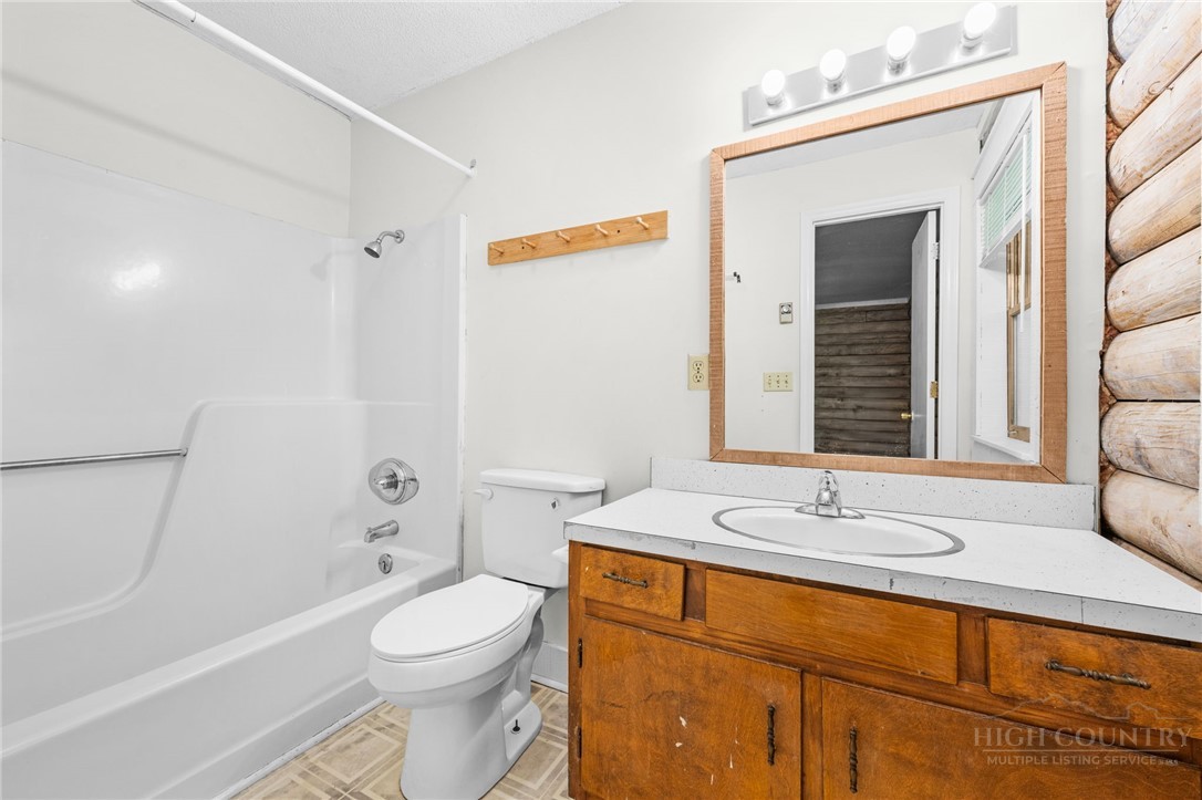 233 Alpine Acres Road Vilas, NC 28692 - Photo 14 of 32 a bathroom with a sink a toilet and shower