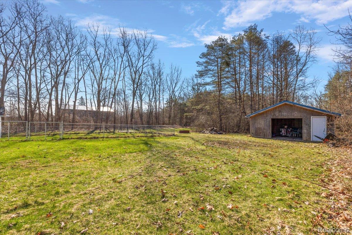 View of yard with an outbuilding and a detached garage