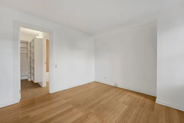 a view of a room with wooden floor