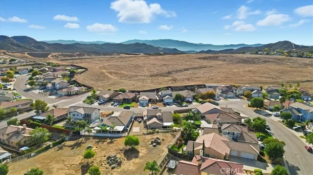 an aerial view of residential houses with outdoor space and trees