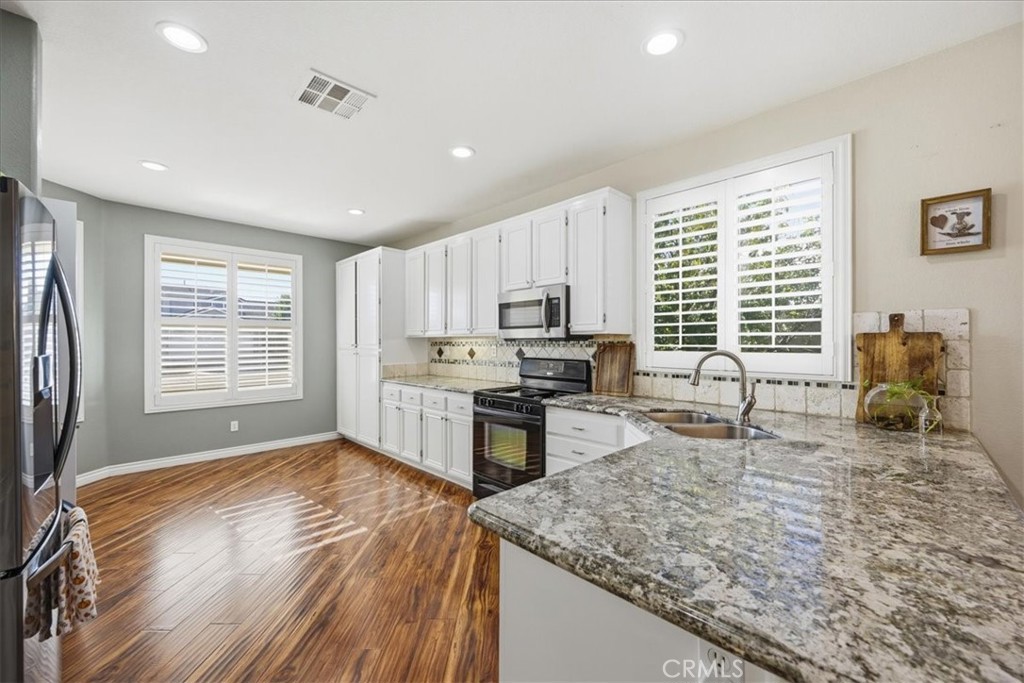 24884 Butterchurn Road Wildomar, CA 92595 - Photo 10 of 43 a kitchen with stainless steel appliances granite countertop sink refrigerator and window