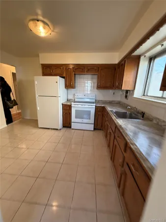 a kitchen with a stove top oven cabinets and a refrigerator