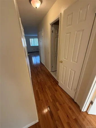 a view of a hallway view with wooden floor and staircase
