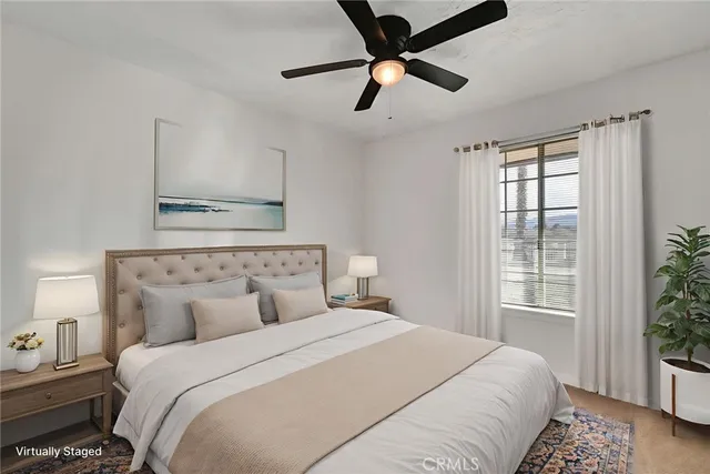 a bedroom with a large bed and a window