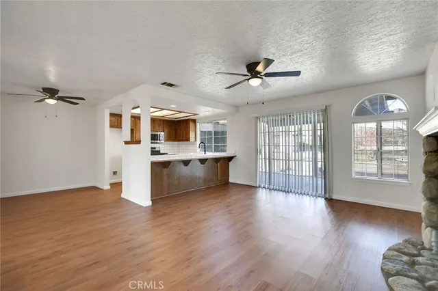 a view of a living room a kitchen and a wooden floor