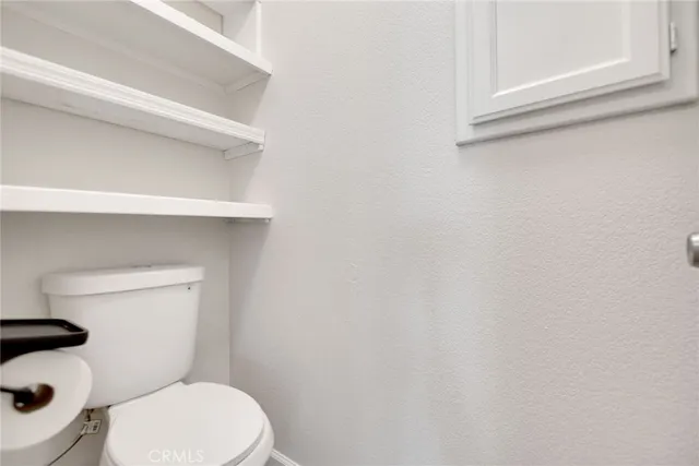 a white toilet sitting next to a window