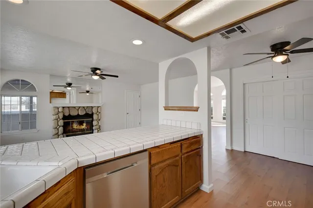 a kitchen with granite countertop a sink cabinets and stainless steel appliances