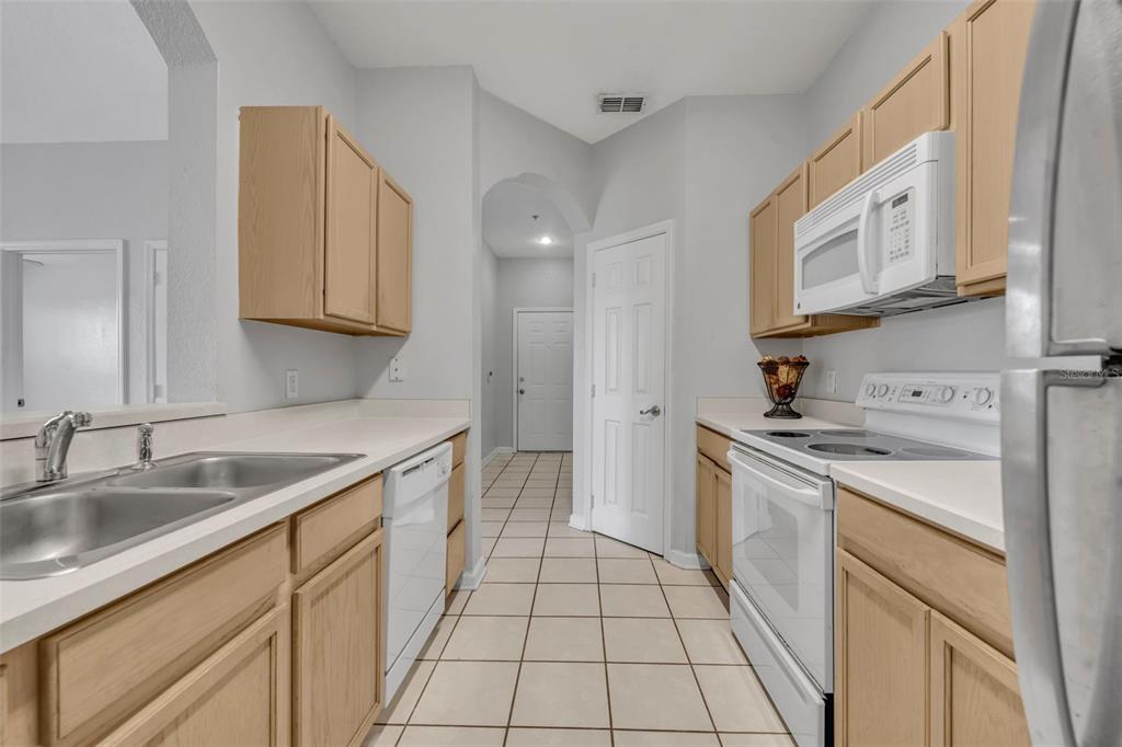 582 Brantley Terrace Way, Unit 304 Altamonte Springs, FL 32714 - Photo 18 of 30 a kitchen with stainless steel appliances granite countertop a sink and a stove