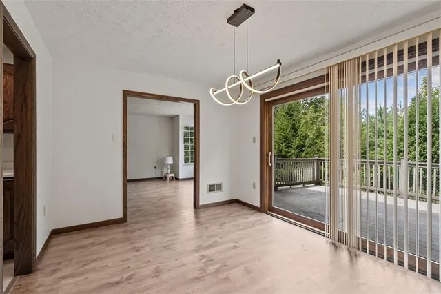 a view of empty room with floor to ceiling window