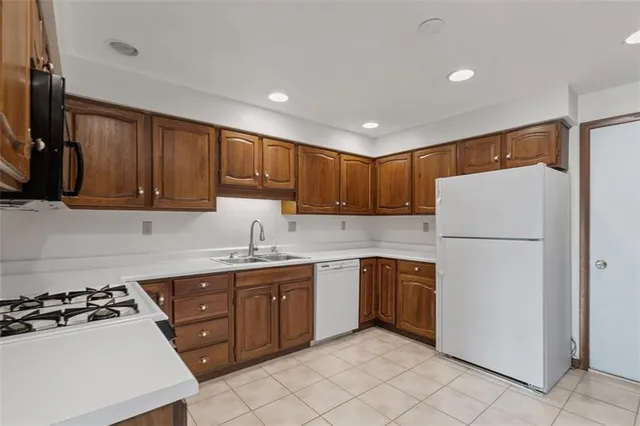 a kitchen with a white stove top oven and refrigerator