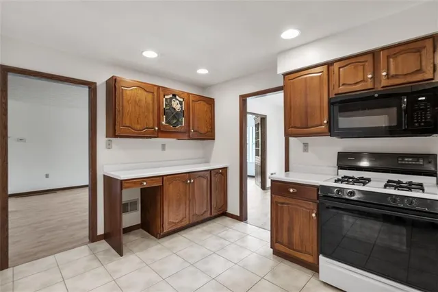 a kitchen with stainless steel appliances granite countertop a stove and a microwave