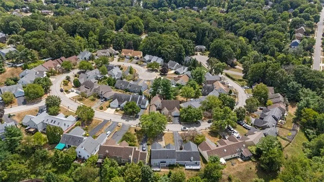 an aerial view of a house with a yard and lake view