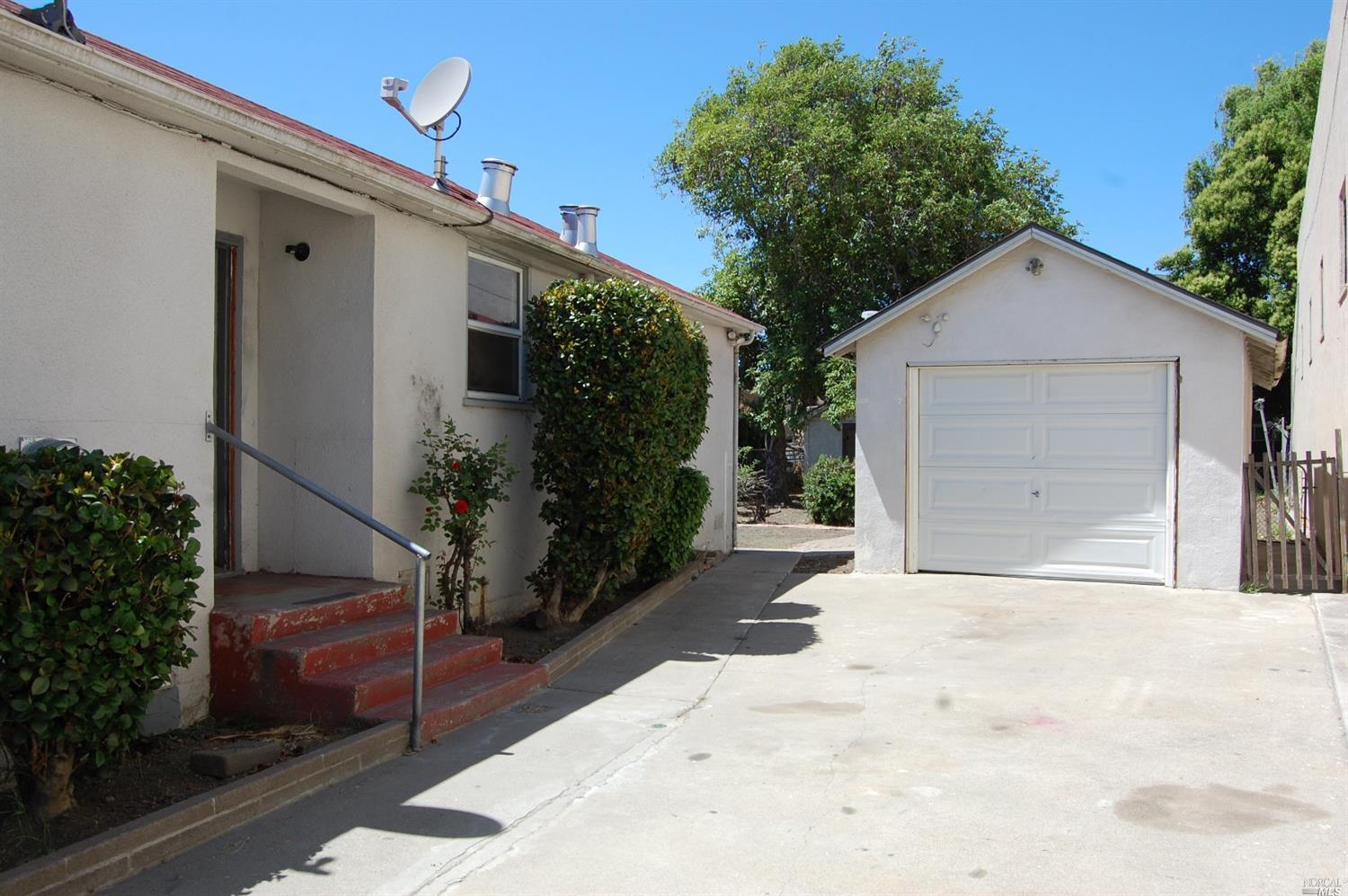 628 First Street Rodeo, CA 94572 - Photo 1 of 1 a view of a house with a yard and garage