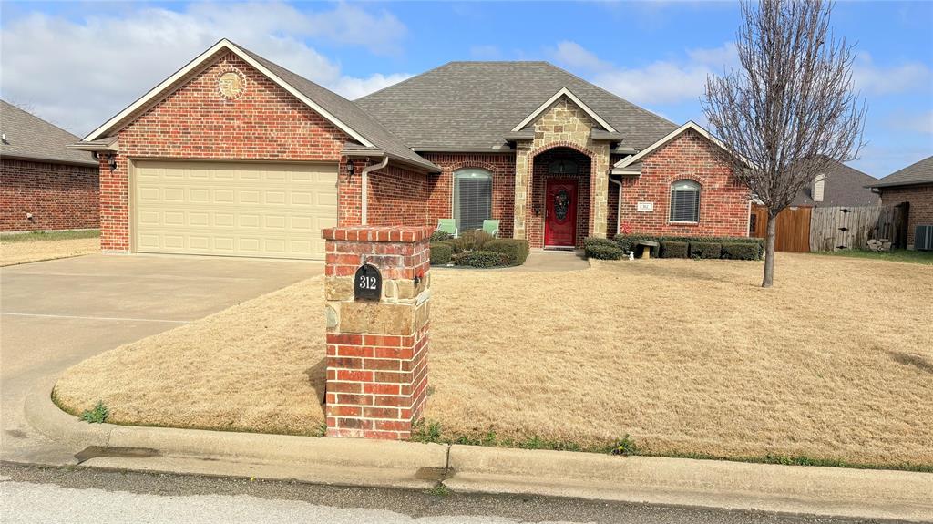 312 McAfee Street Mabank, TX 75147 - Photo 1 of 40 a front view of a house with yard