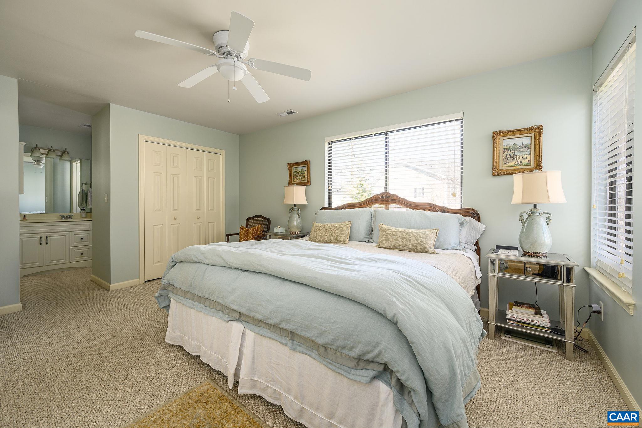 1204 Chatham Ridge Charlottesville, VA 22901 - Photo 11 of 16 a spacious bedroom with a bed and a chandelier