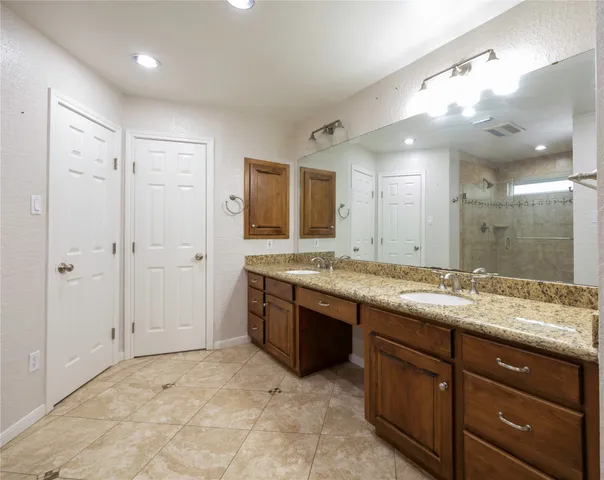 a bathroom with a granite countertop sink mirror and double