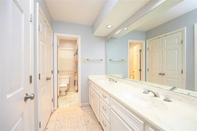 a spacious bathroom with a bathtub sink and mirror