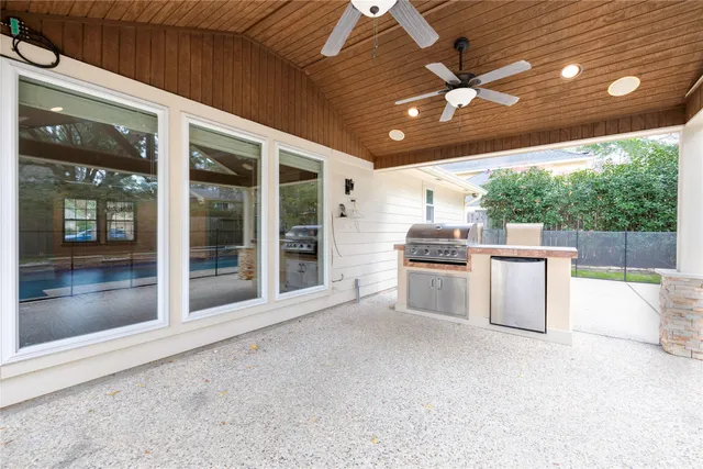 a view of kitchen with sink and refrigerator