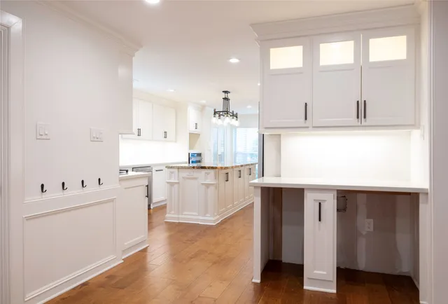 a living room with stainless steel appliances kitchen island granite countertop a sink and cabinets
