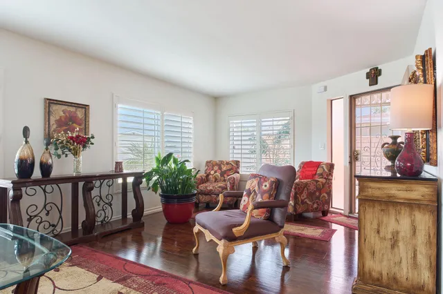 a living room with furniture and a potted plant