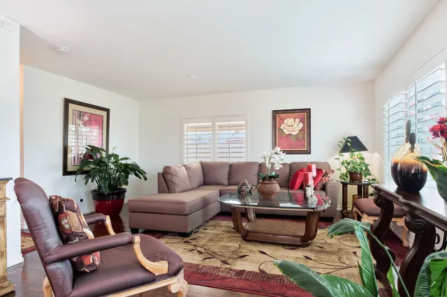 a living room with furniture and a potted plant