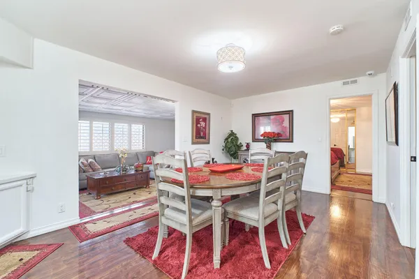 a view of a dining room with furniture and wooden floor