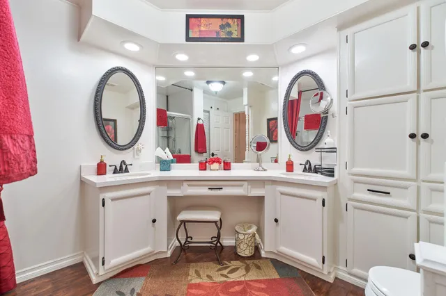 a bathroom with a sink mirror vanity and toilet