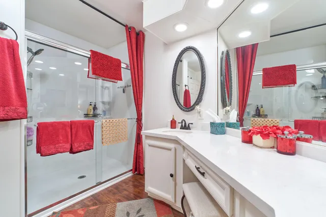 a spacious bedroom with a bed and a chandelier