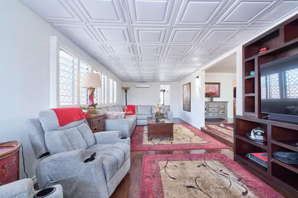 a living room with furniture and a chandelier