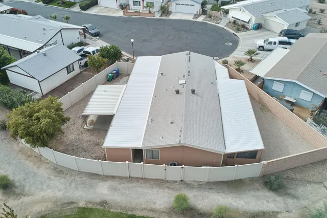 an aerial view of a house with a yard and potted plants