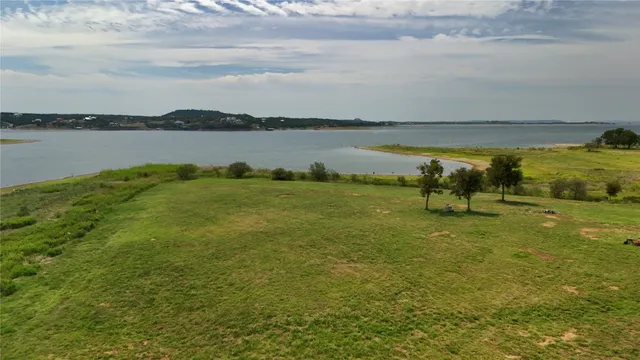 a view of a lake with houses in the back